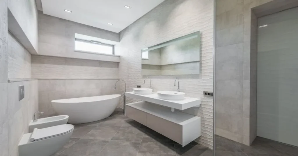 Stylish gray and white bathroom featuring a spacious shower